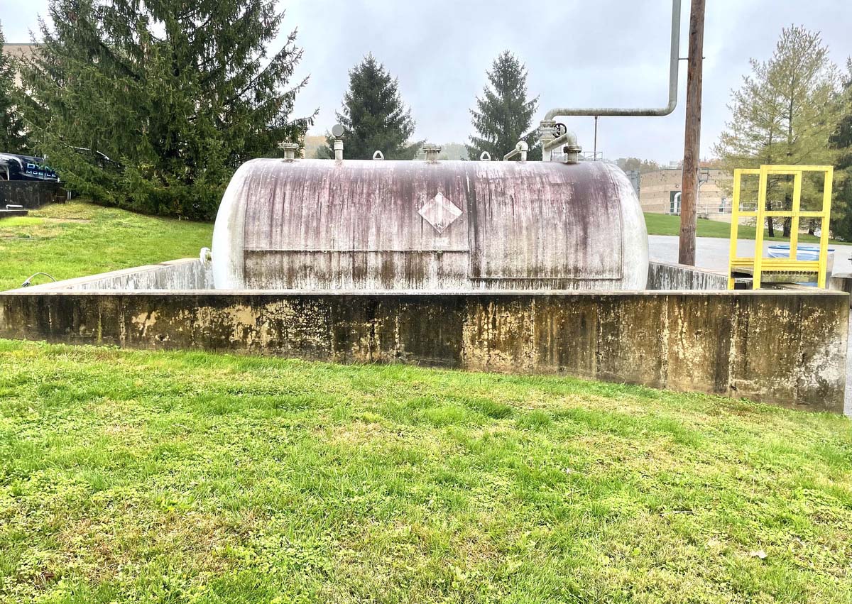 outdoor propane tank that is covered in dirt and grime